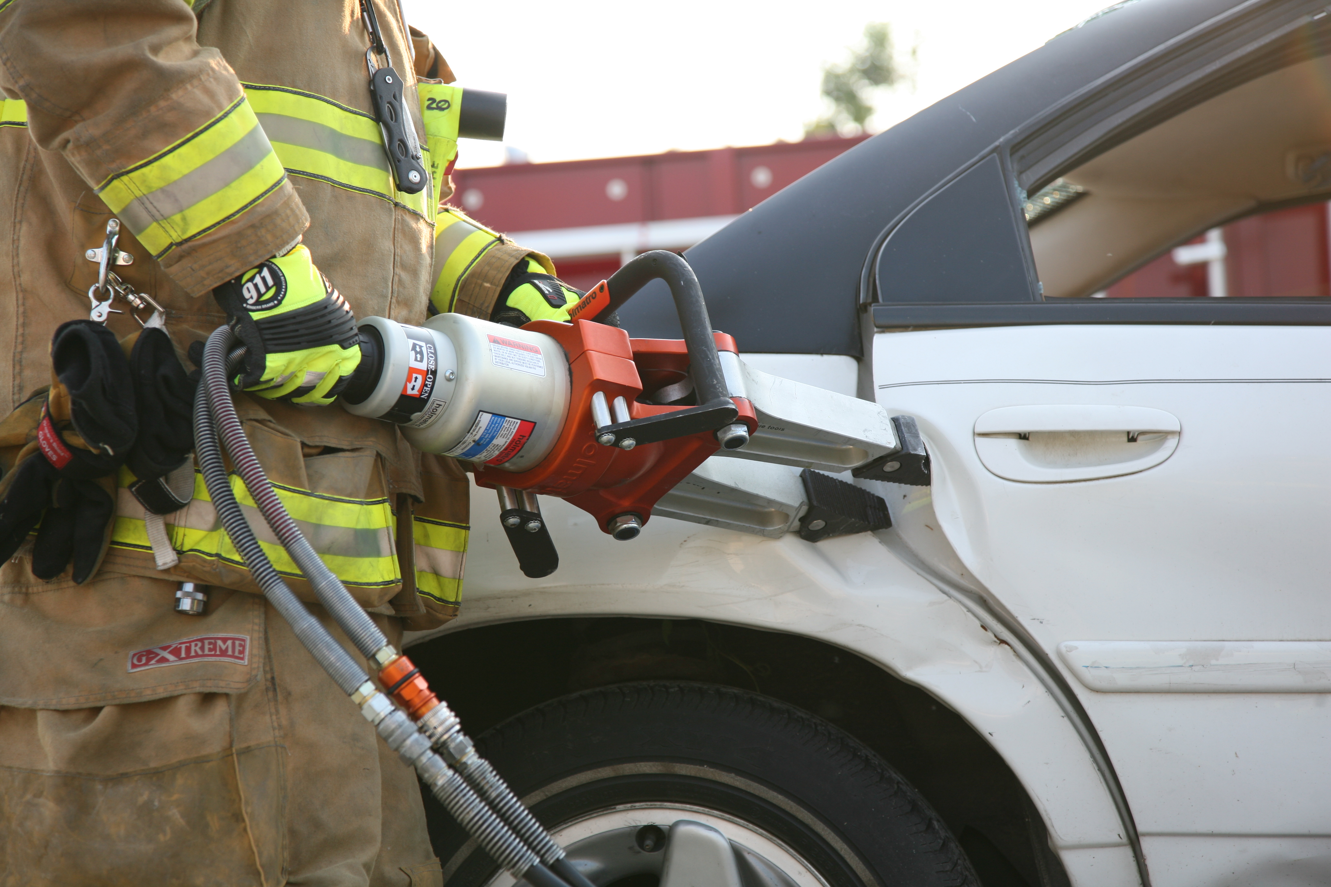 Hydraulic spreaders, commonly referred to as the "Jaws of Life", being used to open a car door
